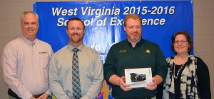 (From left) Hardy Telecommunications Director of Customer Service and Sales, Marketing and Human Resources Derek Barr, East Hardy High Assistant Principal Chad Williams, EHHS teacher Keith Miller and EHHS Principal Jennifer Strawderman display the Canon Vixia HF camcorder recently donated to the school. Hardy and the school split the cost of the video equipment.